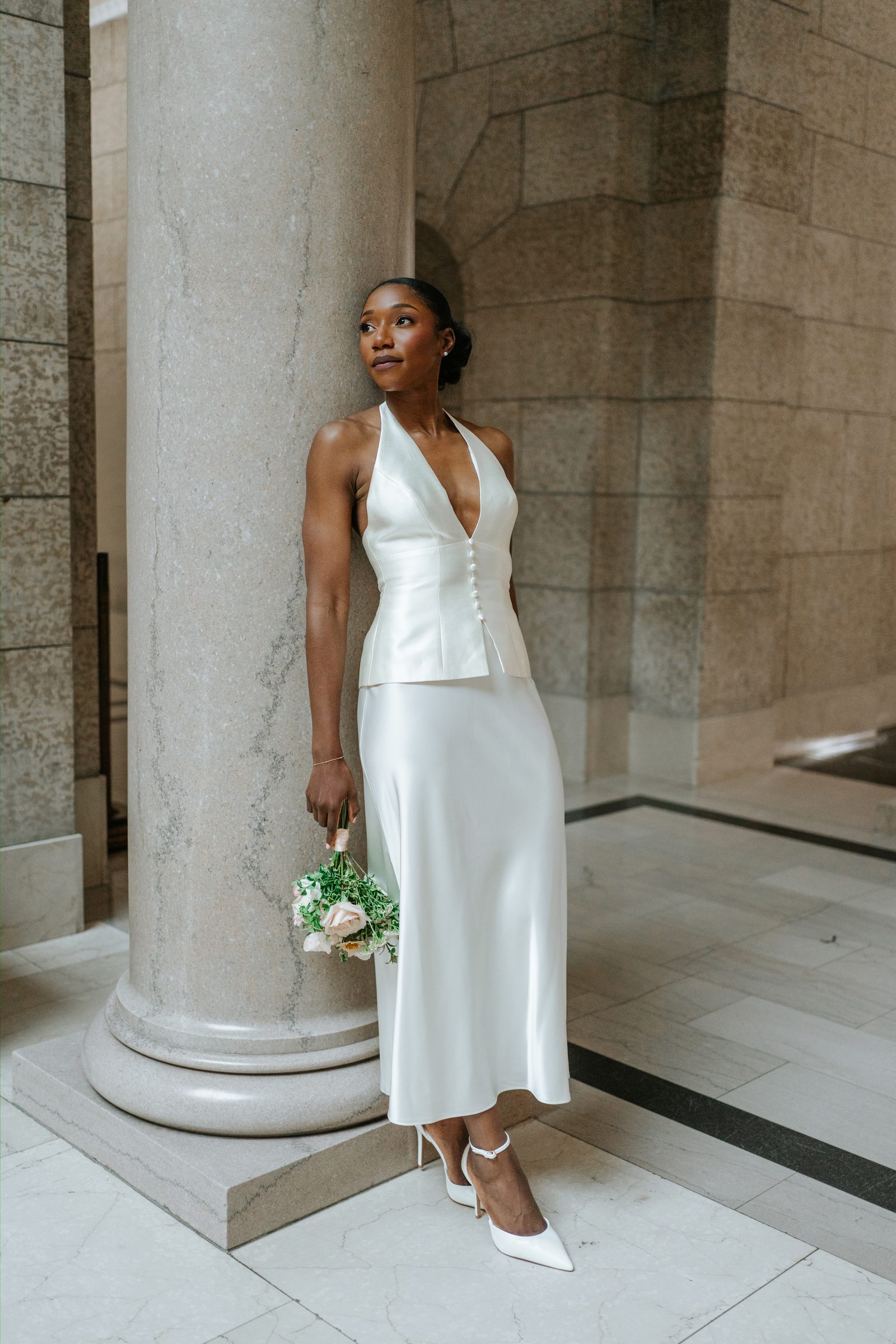 Tobi and Emeka together inside the Manitoba Legislative Building rotunda — couple portrait, warm marble light, Winnipeg