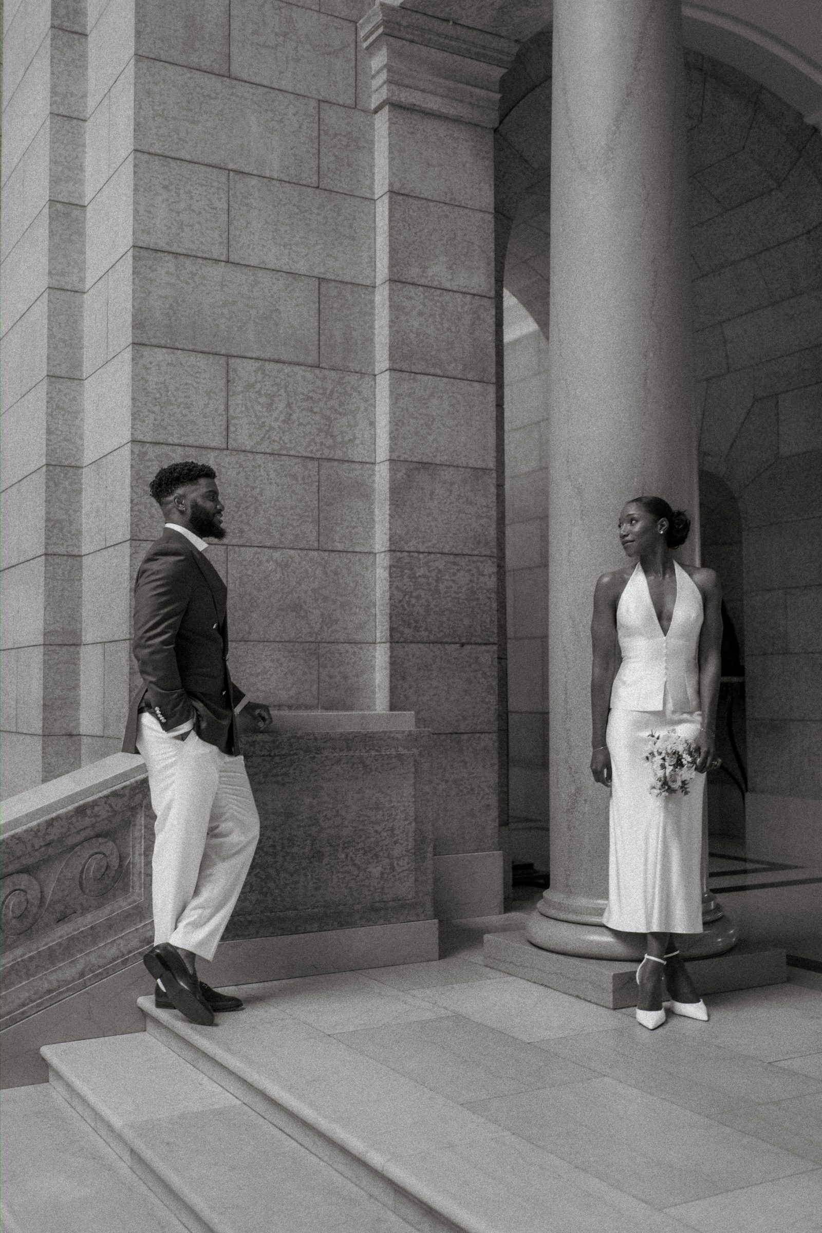 Tobi and Emeka at the Manitoba Legislative Building — outdoor couple portrait in the colonnade, Winnipeg wedding photography