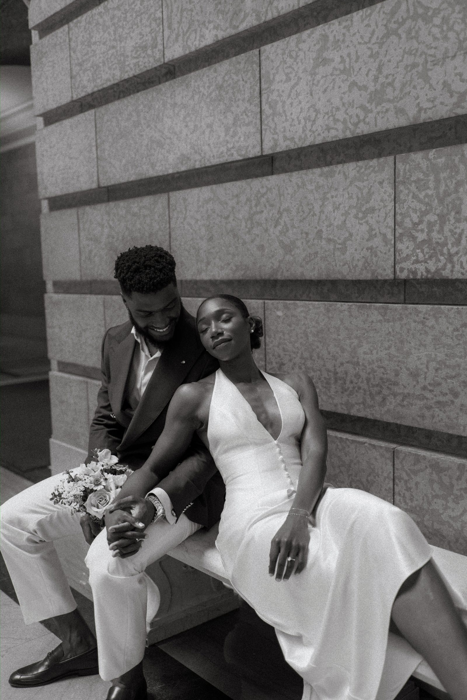 Emeka and Tobi together in the Legislative Building rotunda — couple portrait at the ornate marble balustrade, Winnipeg