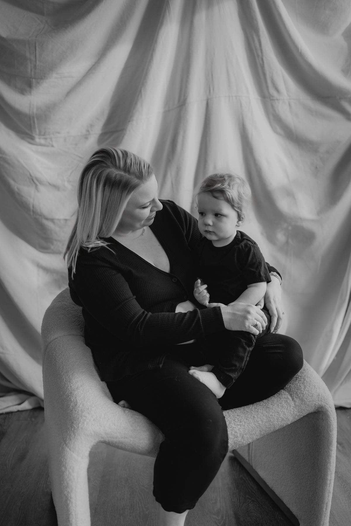 Black and white mother and toddler portrait in studio chair — Winnipeg family photographer Ngo Photography